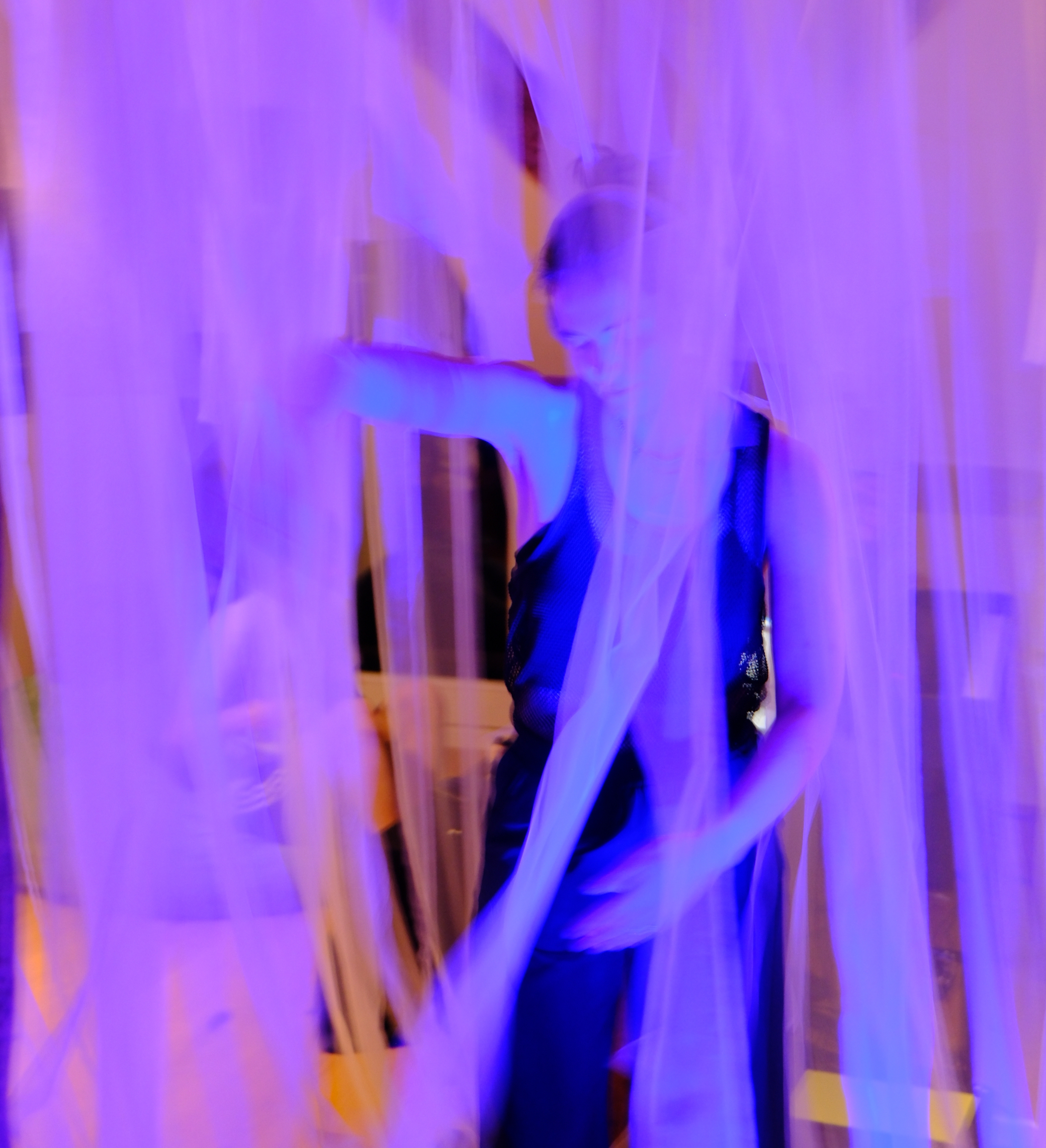 A figure moving through the veil, dissolving into blue