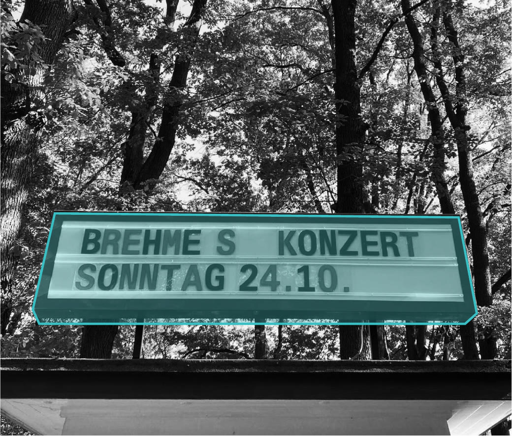 Illuminated sign announcing a Sunday concert, marked in teal